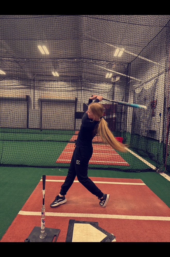 Hailey Toney mid-swing in E-lete gear at the batting cage